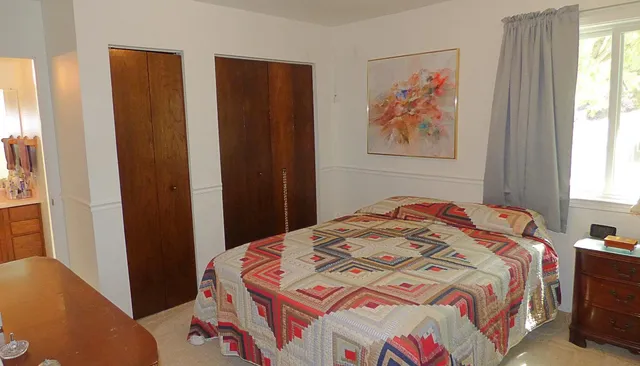 a bedroom with a bed and a window