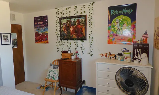 a view of a workspace with furniture and wooden floor