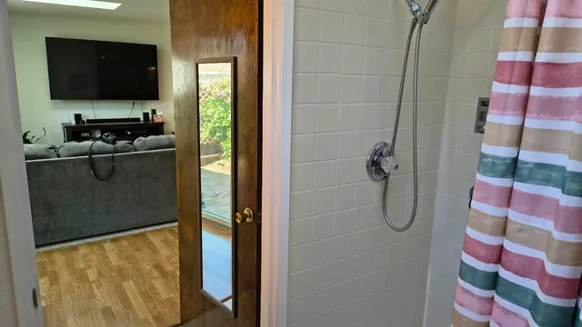 a bathroom with a sink a toilet and a shower curtain