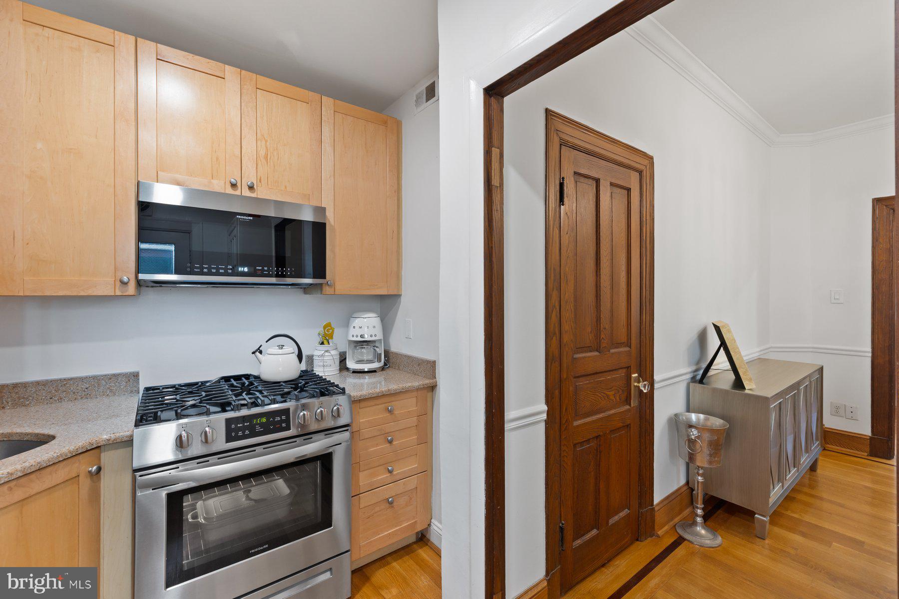 3020 Dent Place Northwest, Unit 30W Washington, DC 20007 - Photo 14 of 37 a kitchen with stainless steel appliances granite countertop a stove a microwave and cabinets