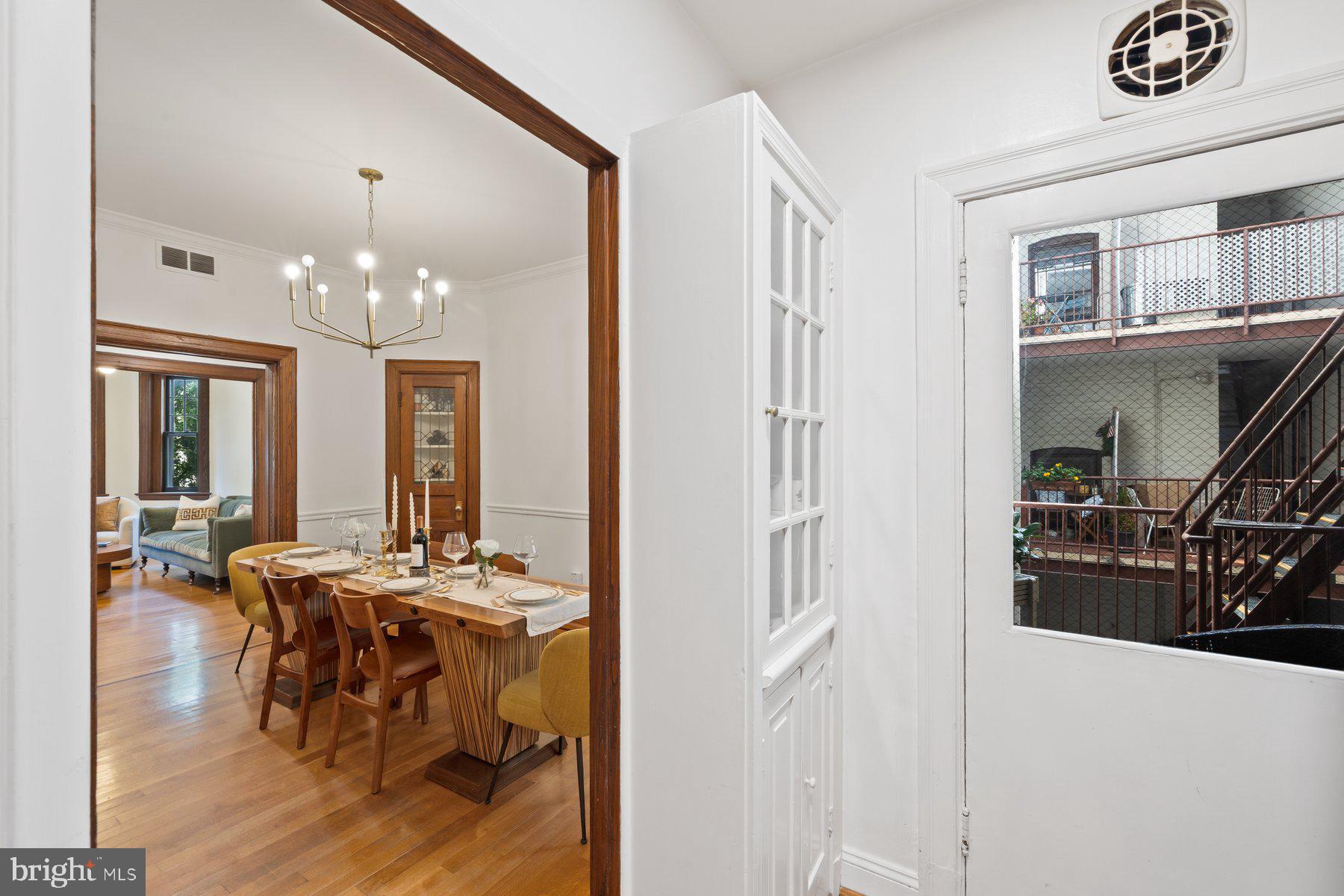 3020 Dent Place Northwest, Unit 30W Washington, DC 20007 - Photo 15 of 37 a dining room with wooden floor and chandelier