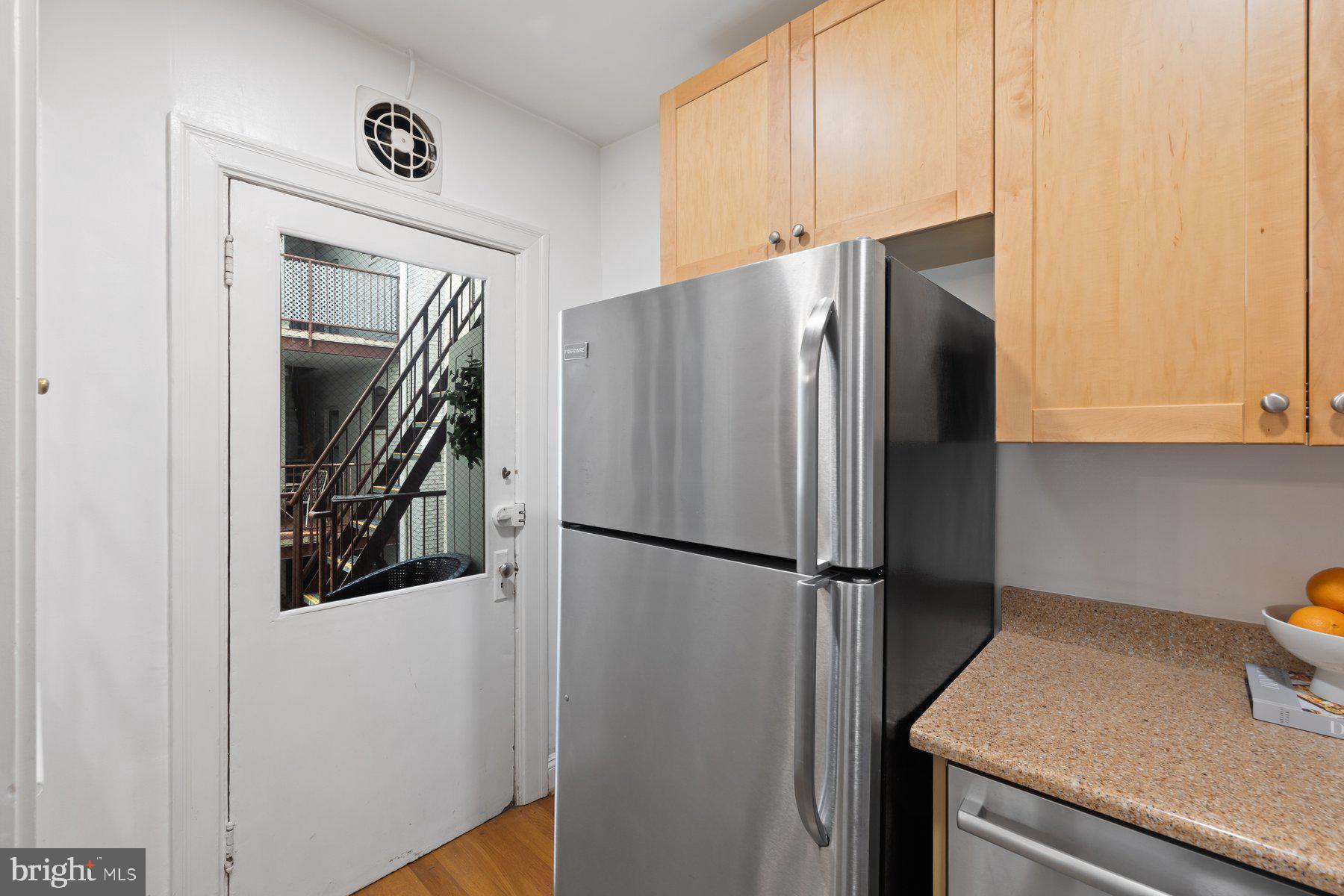 3020 Dent Place Northwest, Unit 30W Washington, DC 20007 - Photo 16 of 37 a metallic refrigerator freezer sitting in a kitchen