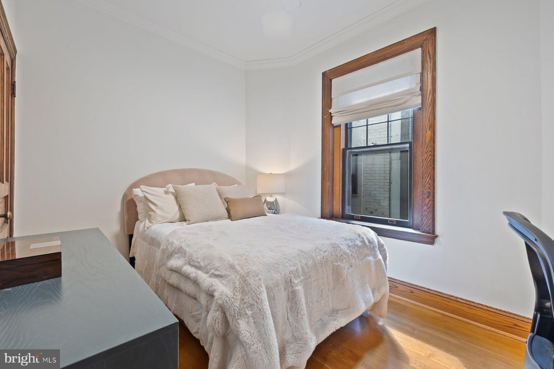 3020 Dent Place Northwest, Unit 30W Washington, DC 20007 - Photo 17 of 37 a bedroom with bed and a window