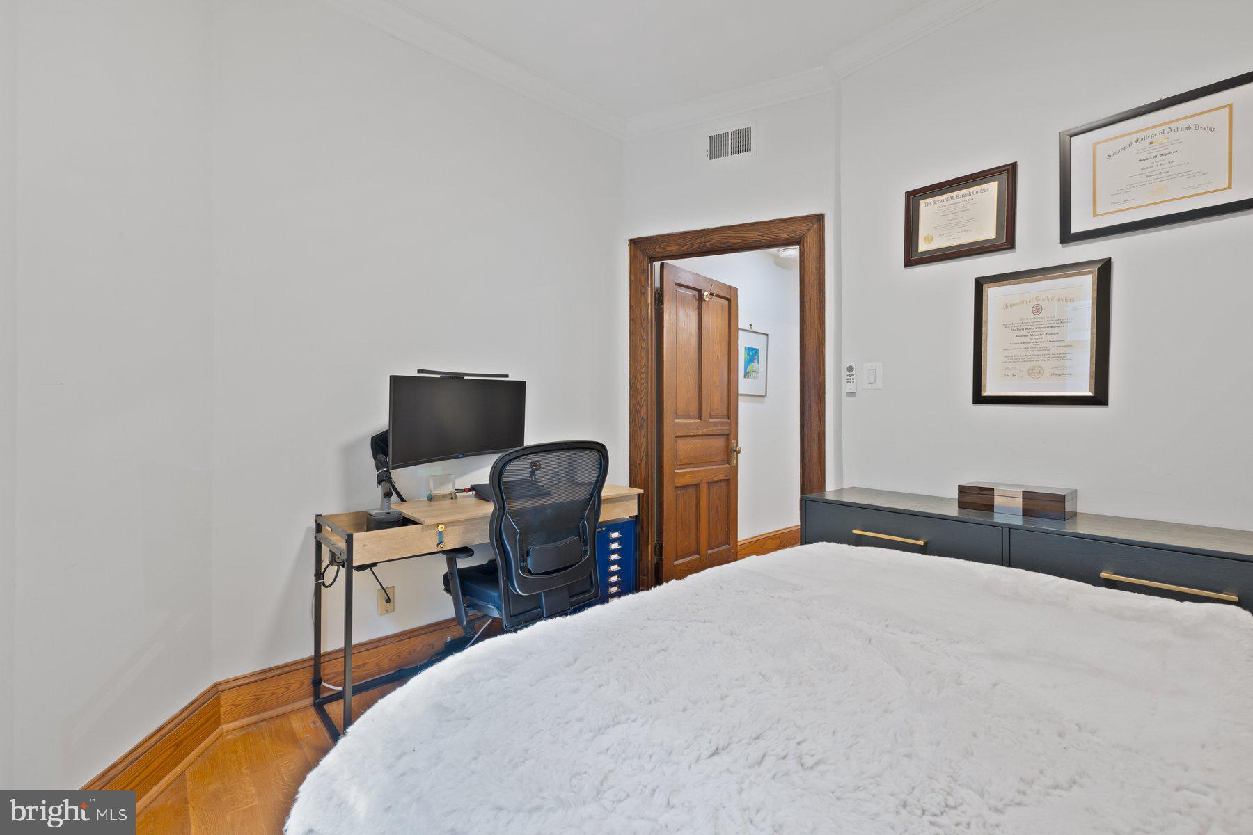 3020 Dent Place Northwest, Unit 30W Washington, DC 20007 - Photo 18 of 37 a bedroom with a bed and a desk