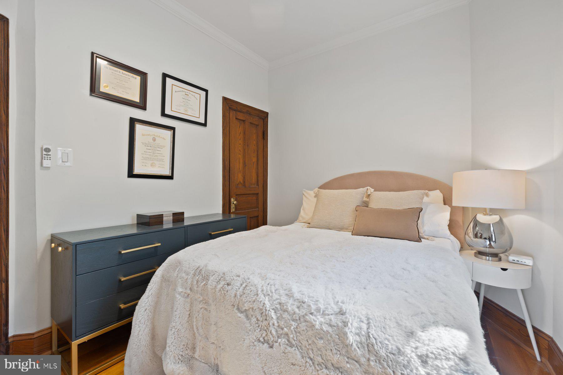 3020 Dent Place Northwest, Unit 30W Washington, DC 20007 - Photo 19 of 37 a bedroom with a bed and a lamp