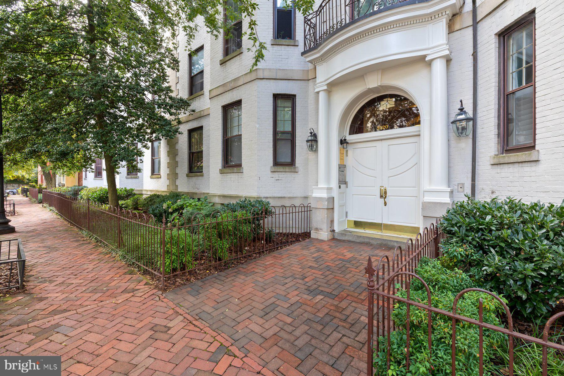 3020 Dent Place Northwest, Unit 30W Washington, DC 20007 - Photo 2 of 37 a front view of a house with garden