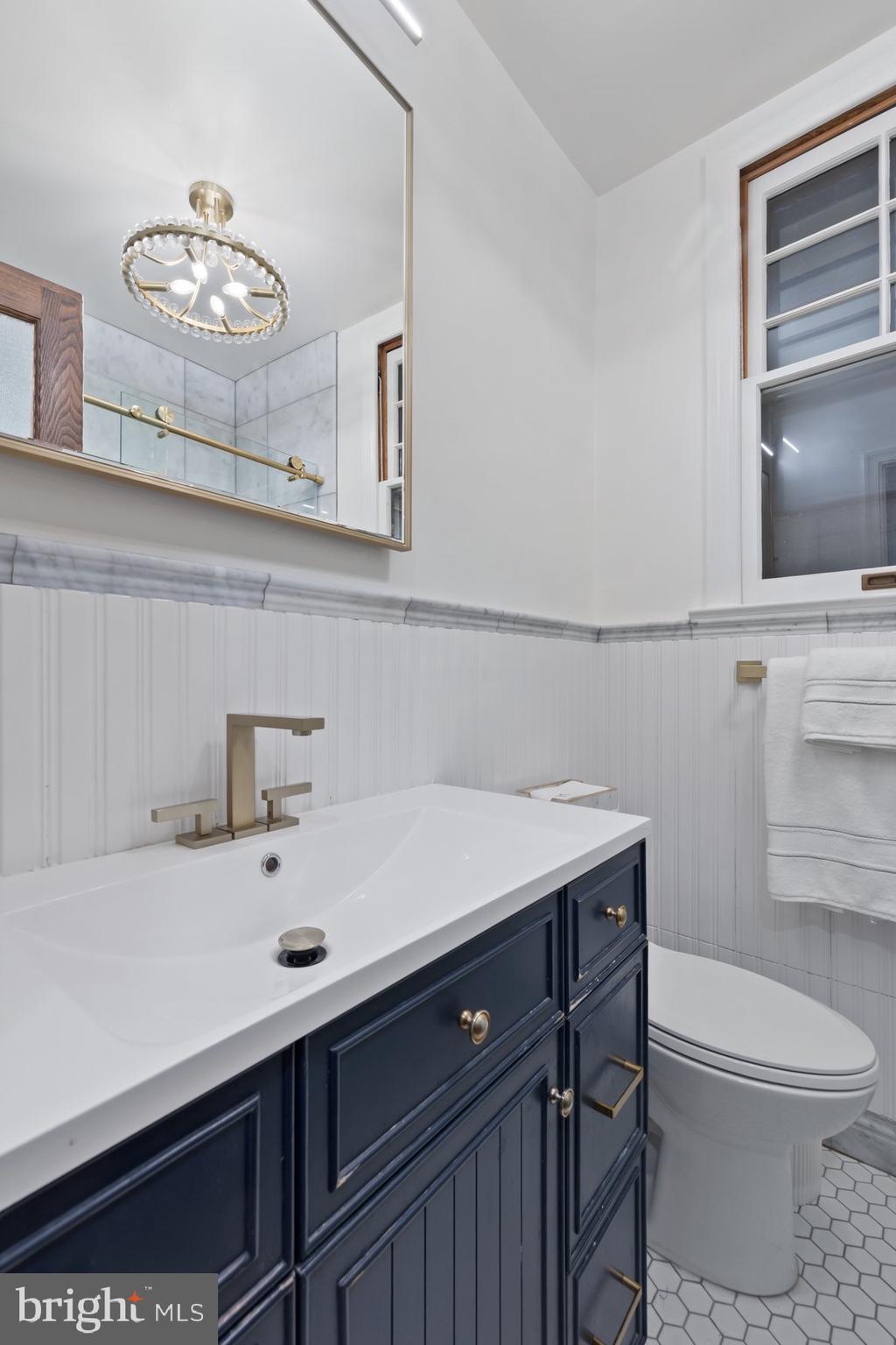 3020 Dent Place Northwest, Unit 30W Washington, DC 20007 - Photo 23 of 37 a bathroom with a sink a toilet and a mirror