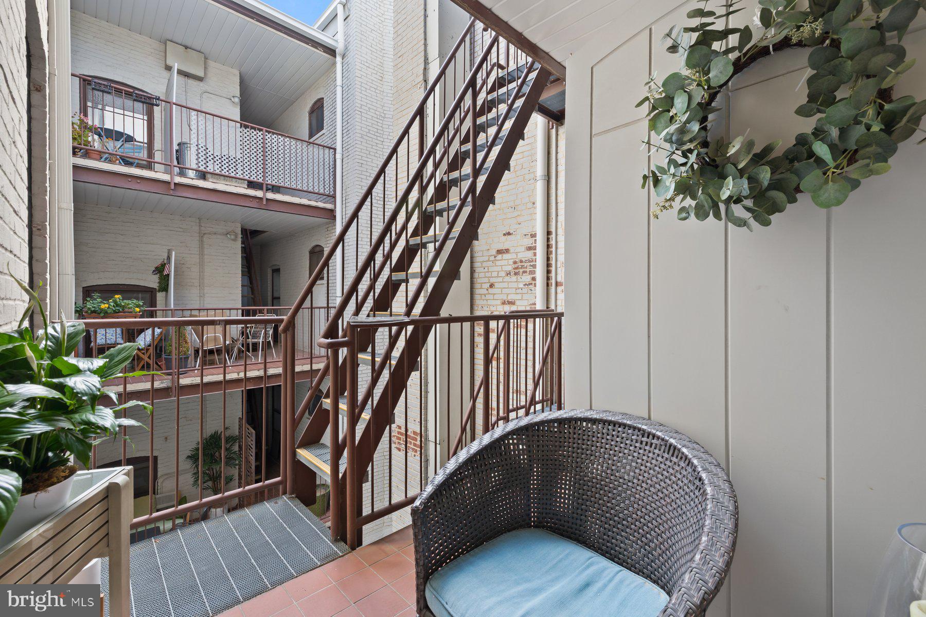 3020 Dent Place Northwest, Unit 30W Washington, DC 20007 - Photo 25 of 37 a view of staircase with wooden floor and a potted plant