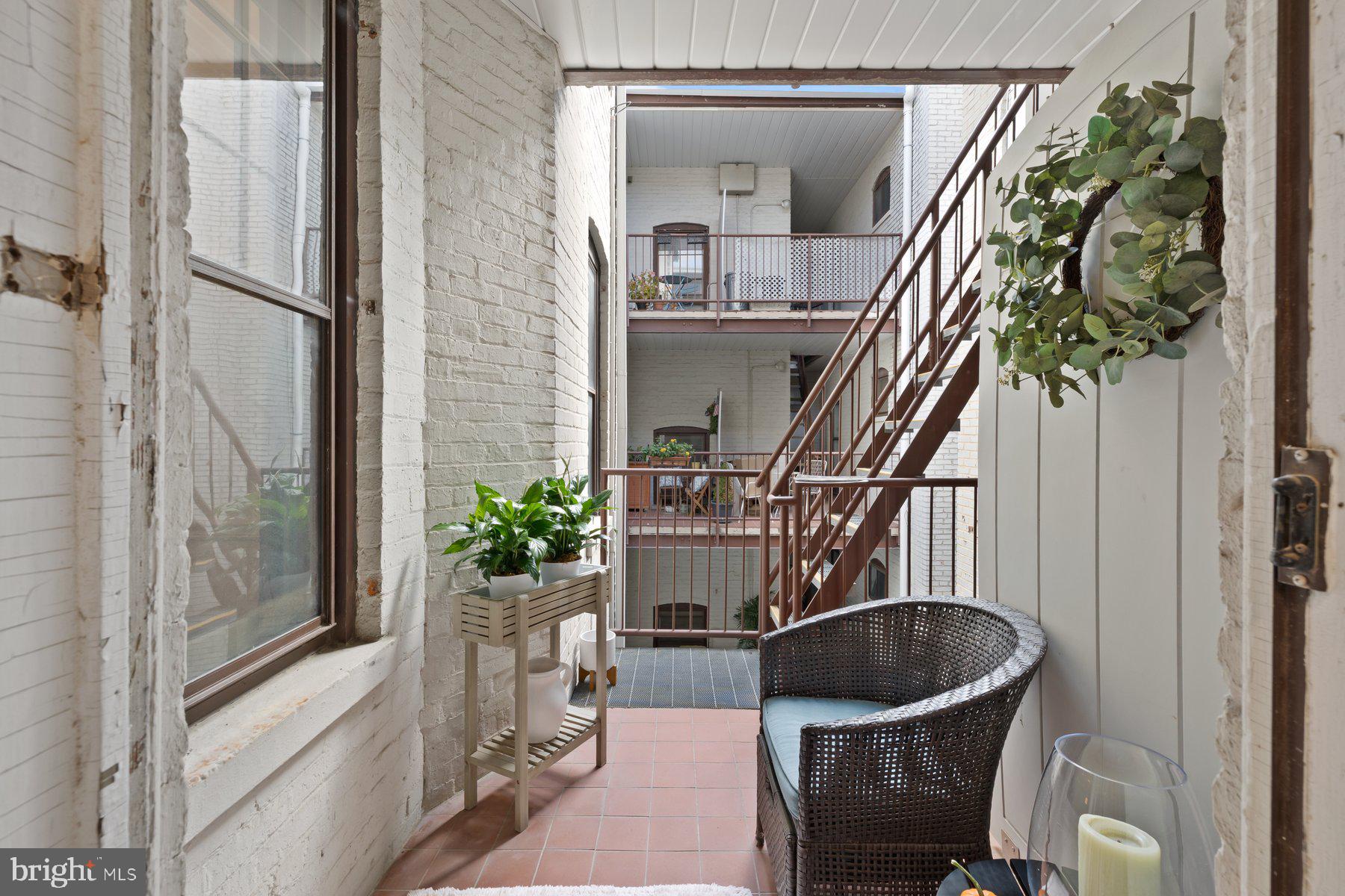 3020 Dent Place Northwest, Unit 30W Washington, DC 20007 - Photo 26 of 37 a living room with furniture and a potted plant