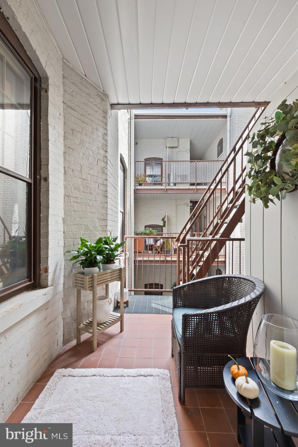 3020 Dent Place Northwest, Unit 30W Washington, DC 20007 - Photo 27 of 37 a living room with furniture potted plant and a window