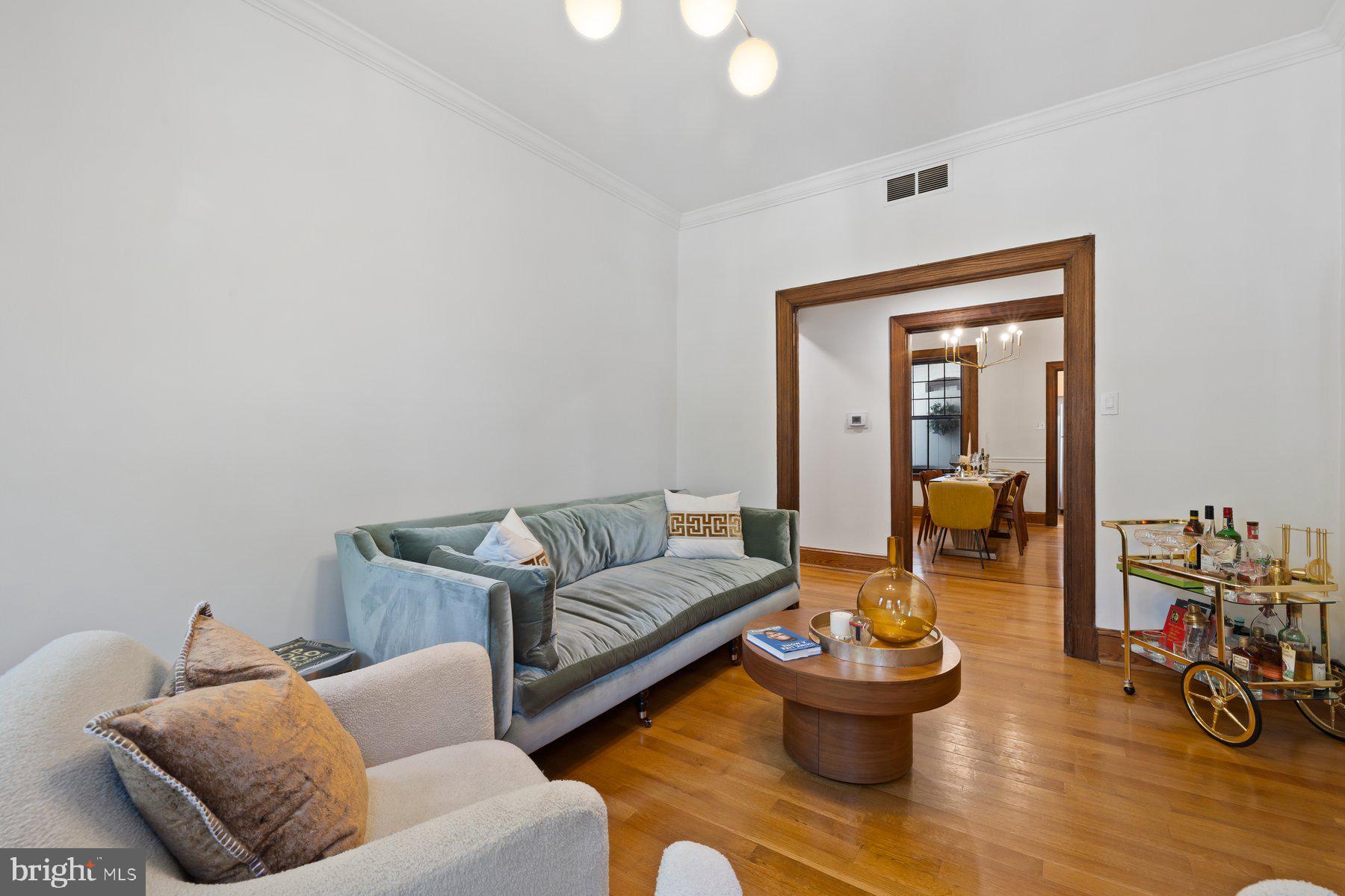3020 Dent Place Northwest, Unit 30W Washington, DC 20007 - Photo 7 of 37 a living room with furniture and a wooden floor