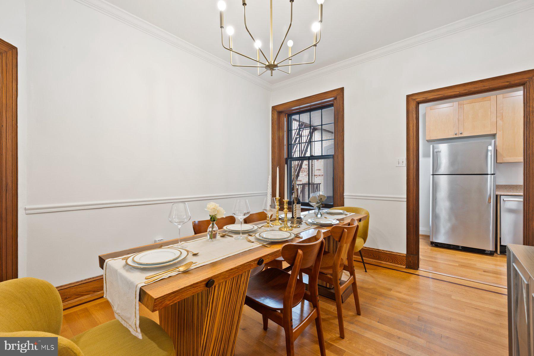 3020 Dent Place Northwest, Unit 30W Washington, DC 20007 - Photo 9 of 37 a dining room with stainless steel appliances a table and chairs