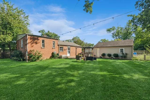 a front view of house with a garden