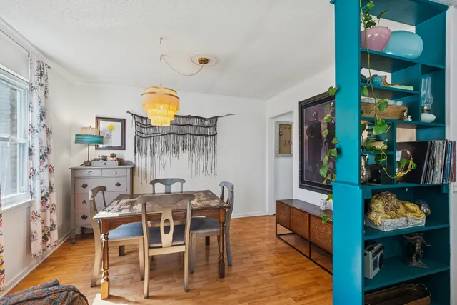 a view of a dining room with furniture and wooden floor