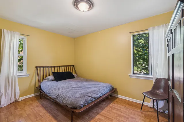 a blue couch sitting in a living room next to a window