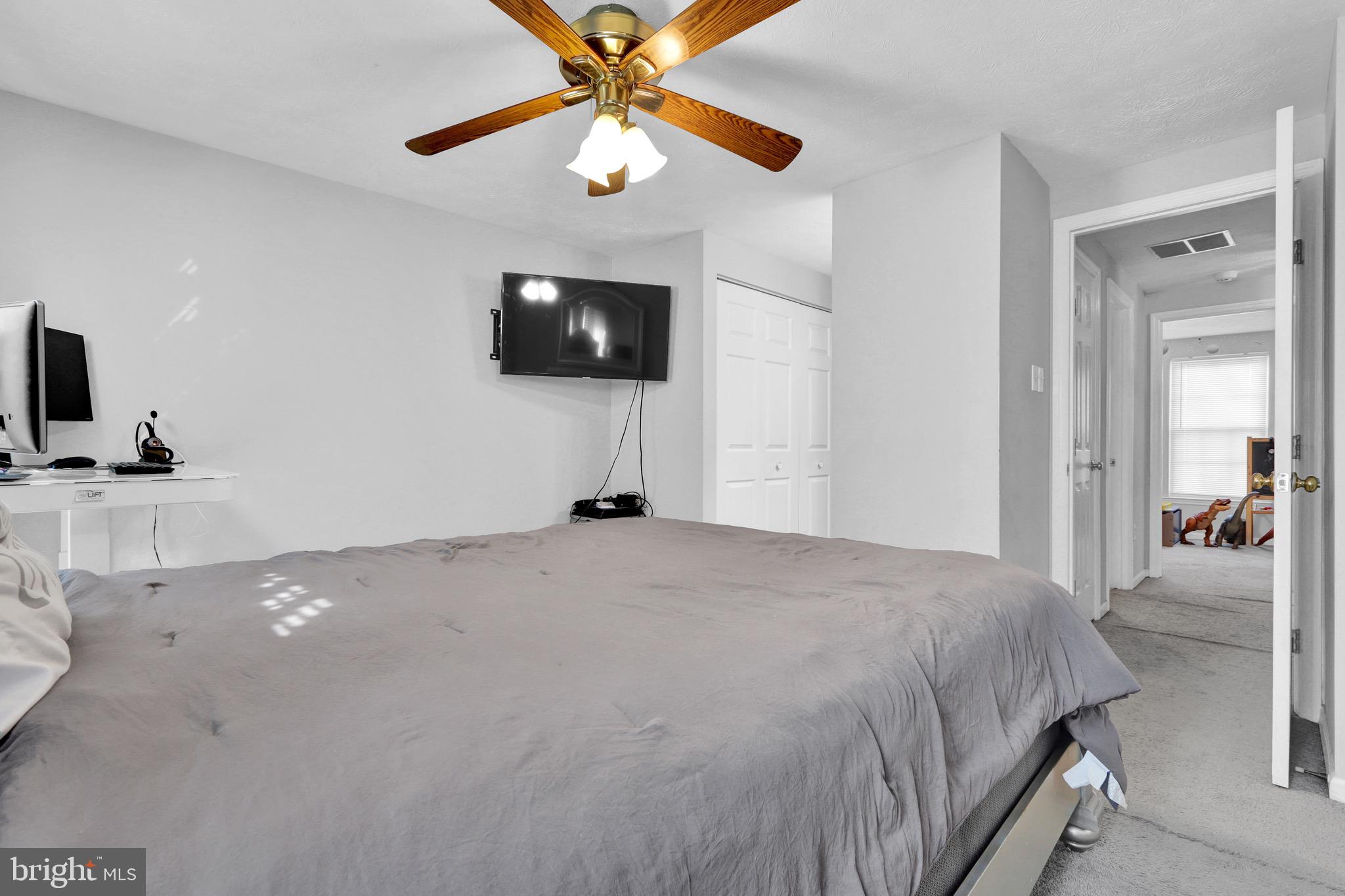 2235 Riding Crop Way Windsor Mill, MD 21244 - Photo 16 of 29 a bedroom with a bed and a flat screen tv