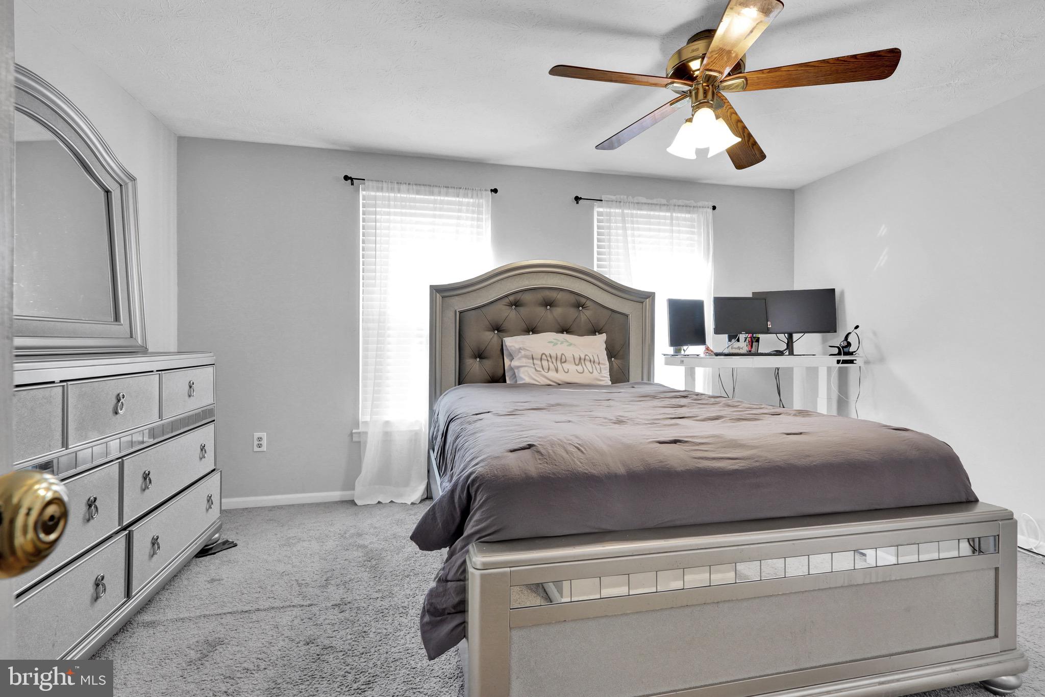 2235 Riding Crop Way Windsor Mill, MD 21244 - Photo 17 of 29 a bedroom with a bed and ceiling fan