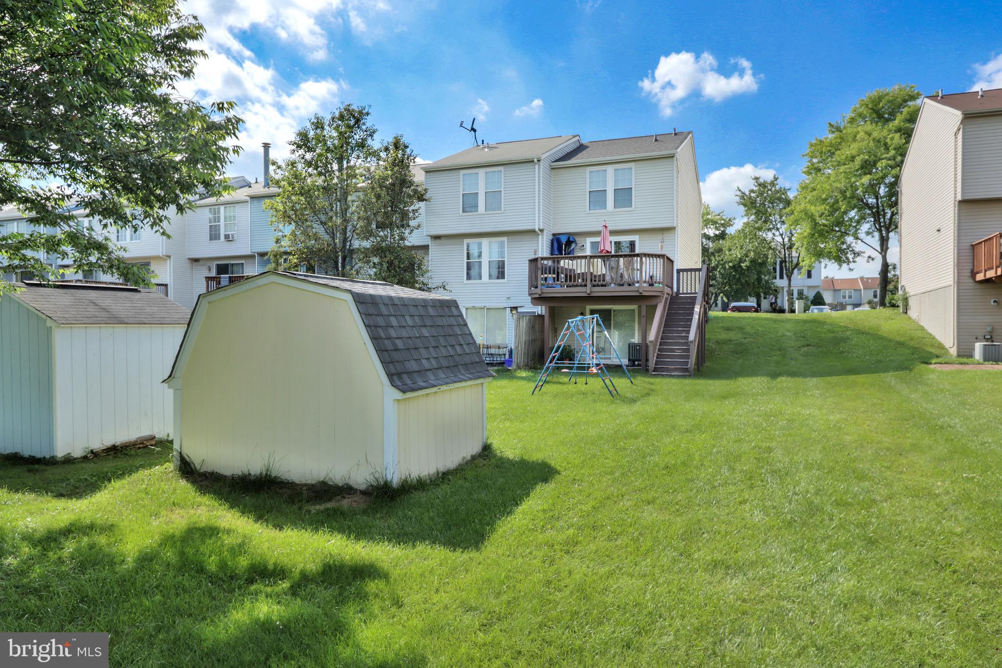 2235 Riding Crop Way Windsor Mill, MD 21244 - Photo 20 of 29 a view of a house with a backyard and a patio