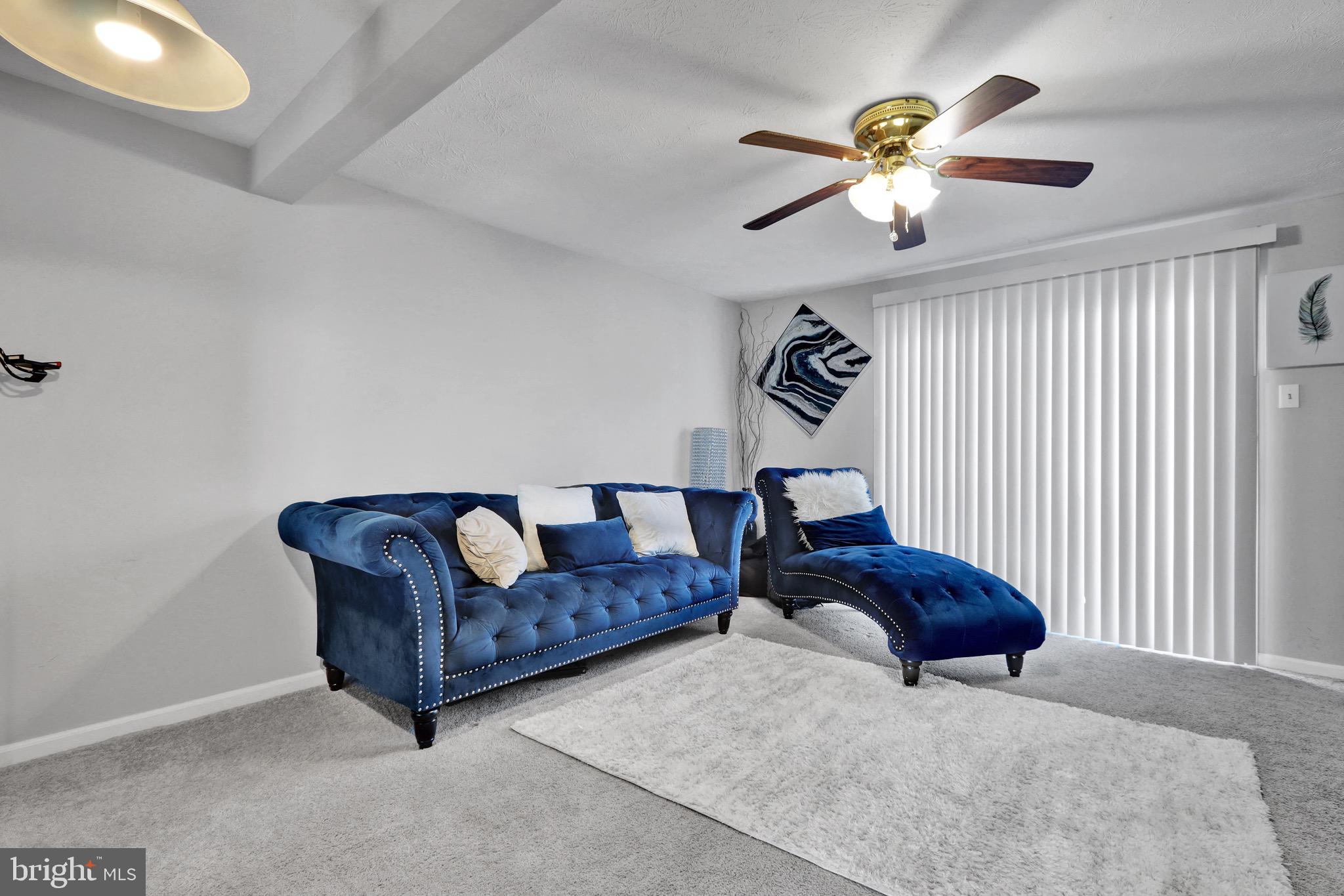 2235 Riding Crop Way Windsor Mill, MD 21244 - Photo 2 of 29 a living room with couches and furniture with a chandelier