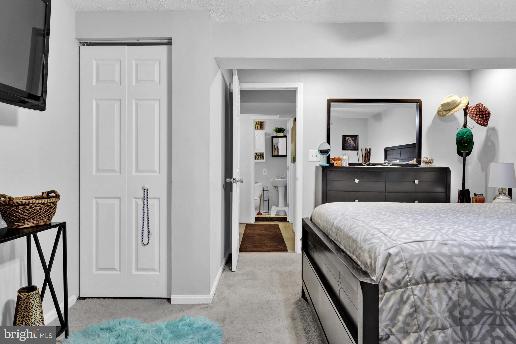 2235 Riding Crop Way Windsor Mill, MD 21244 - Photo 21 of 29 a bedroom with a bed and a flat tv screen on wall