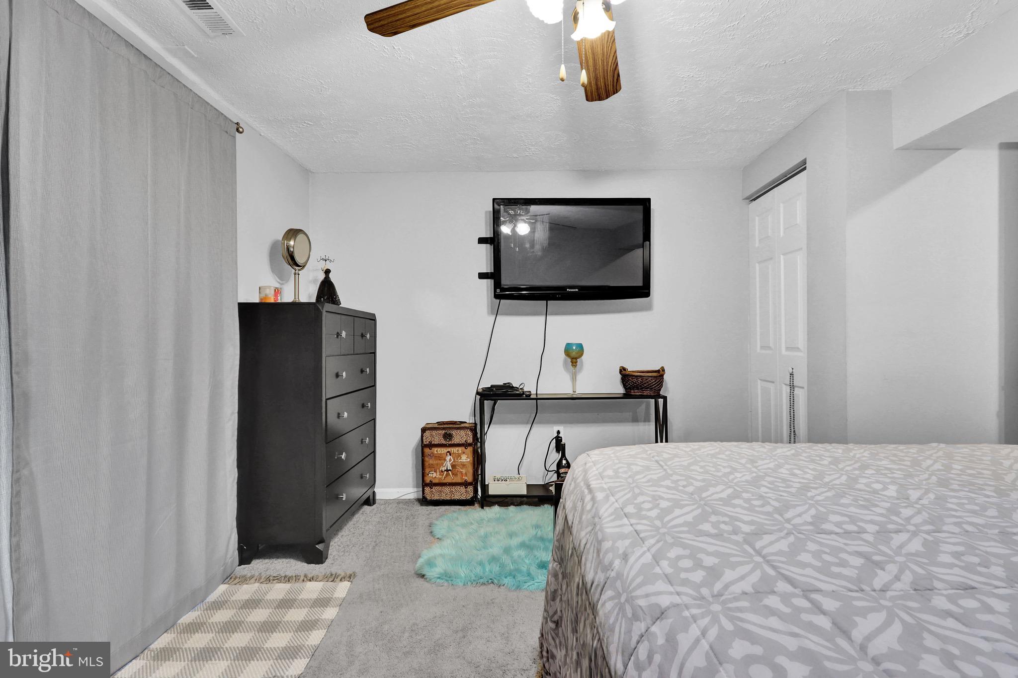 2235 Riding Crop Way Windsor Mill, MD 21244 - Photo 22 of 29 a bedroom with a bed and a flat screen tv