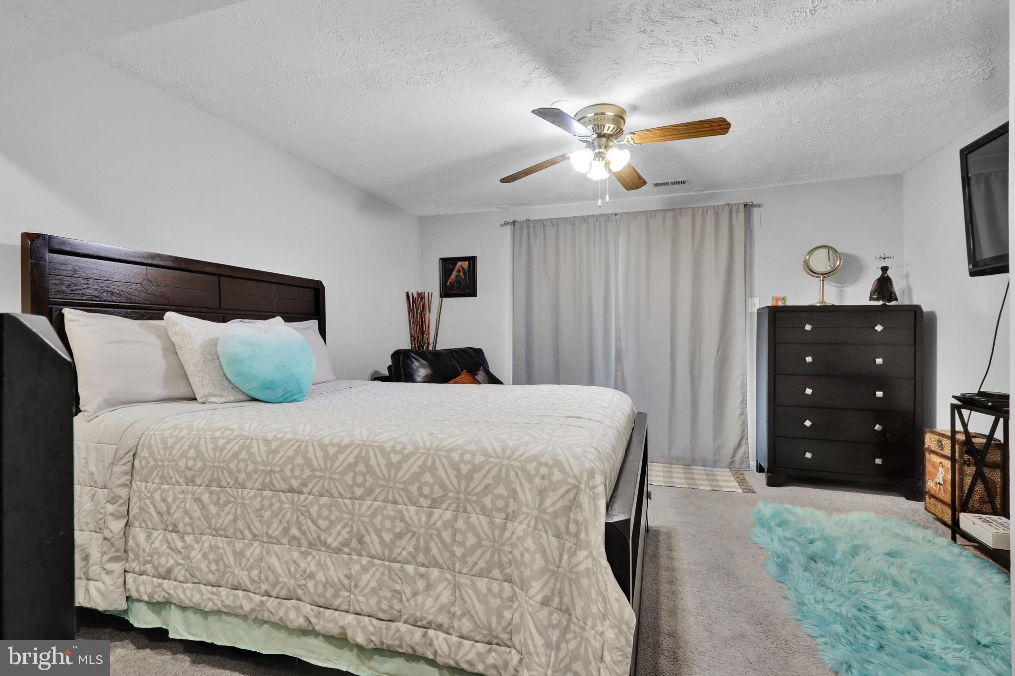 2235 Riding Crop Way Windsor Mill, MD 21244 - Photo 23 of 29 a bedroom with a bed and a chandelier