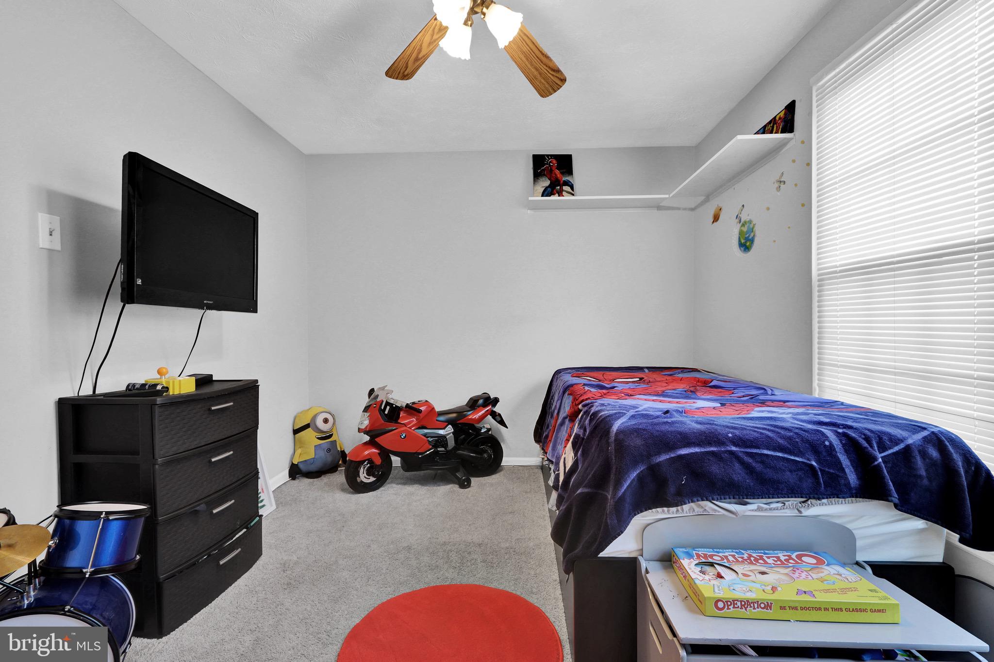 2235 Riding Crop Way Windsor Mill, MD 21244 - Photo 26 of 29 a bedroom with a bed and a flat screen tv
