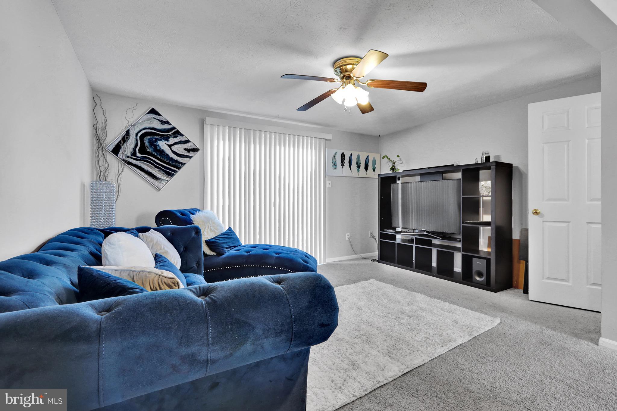 2235 Riding Crop Way Windsor Mill, MD 21244 - Photo 5 of 29 a living room with furniture and a flat screen tv
