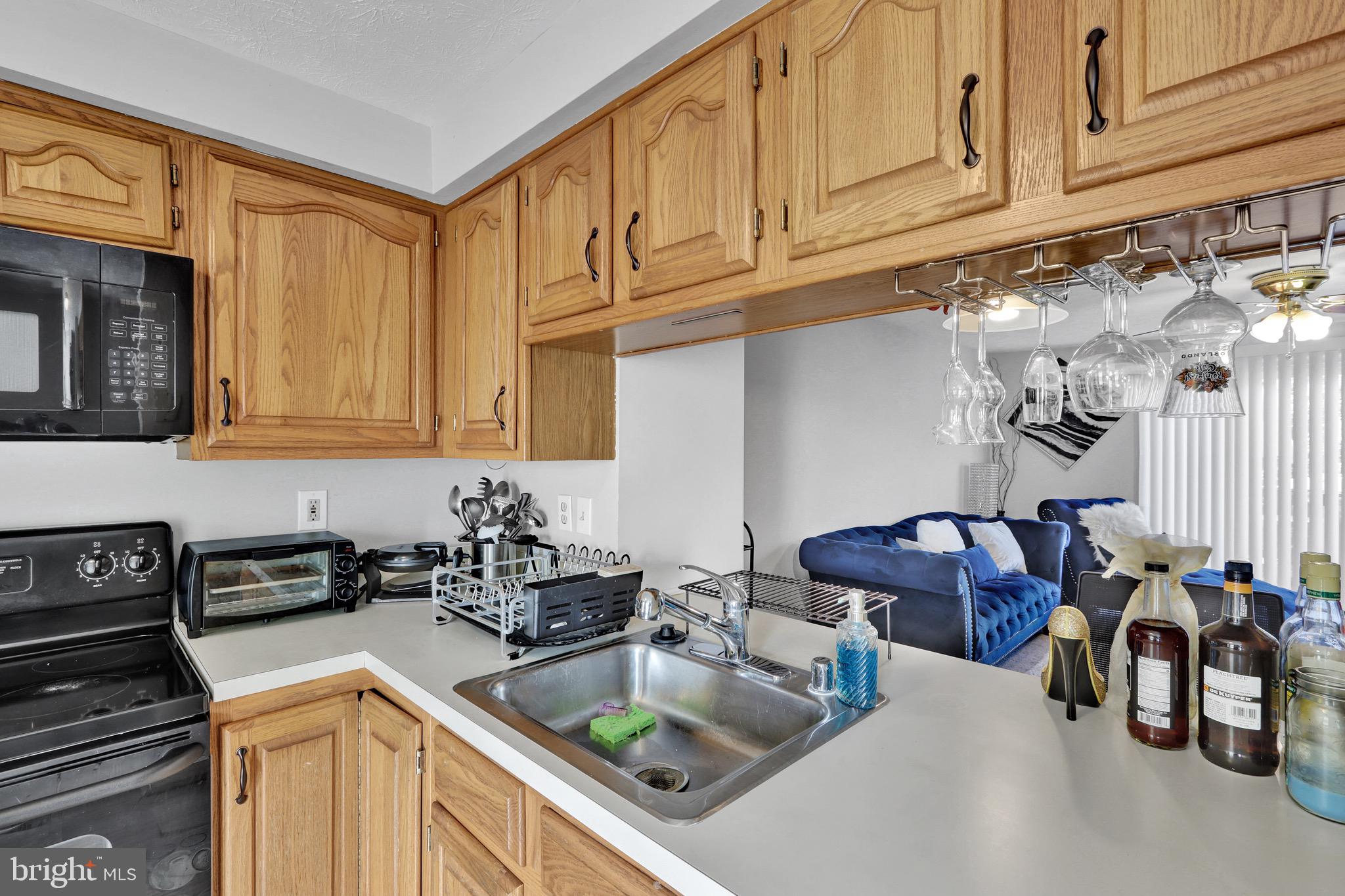 2235 Riding Crop Way Windsor Mill, MD 21244 - Photo 6 of 29 a kitchen with stainless steel appliances granite countertop a sink and cabinets