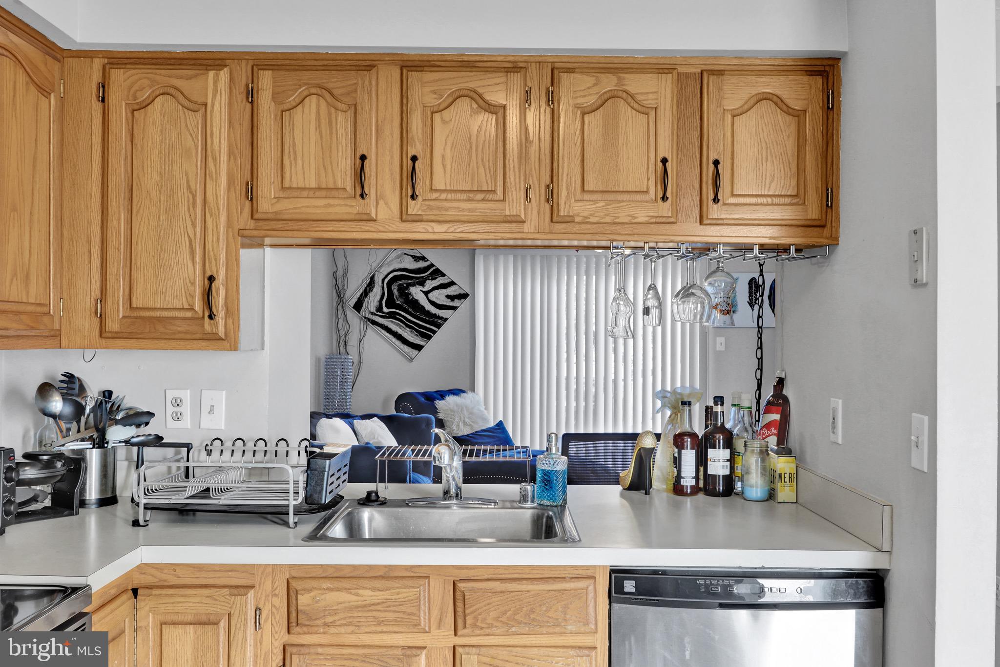 2235 Riding Crop Way Windsor Mill, MD 21244 - Photo 9 of 29 a kitchen with stainless steel appliances granite countertop a sink and cabinets