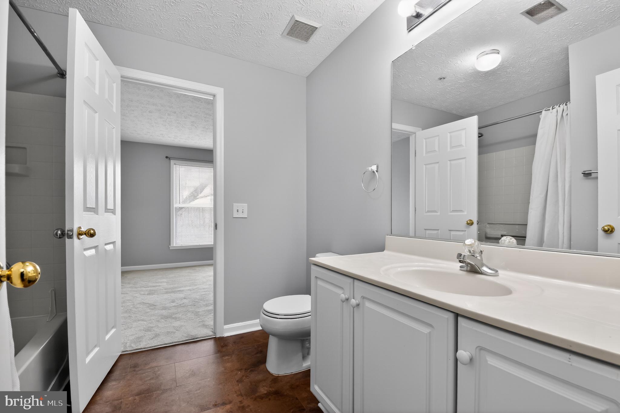 2058 Quaker Way, Unit 12 Annapolis, MD 21401 - Photo 11 of 27 a bathroom with a sink a toilet and shower