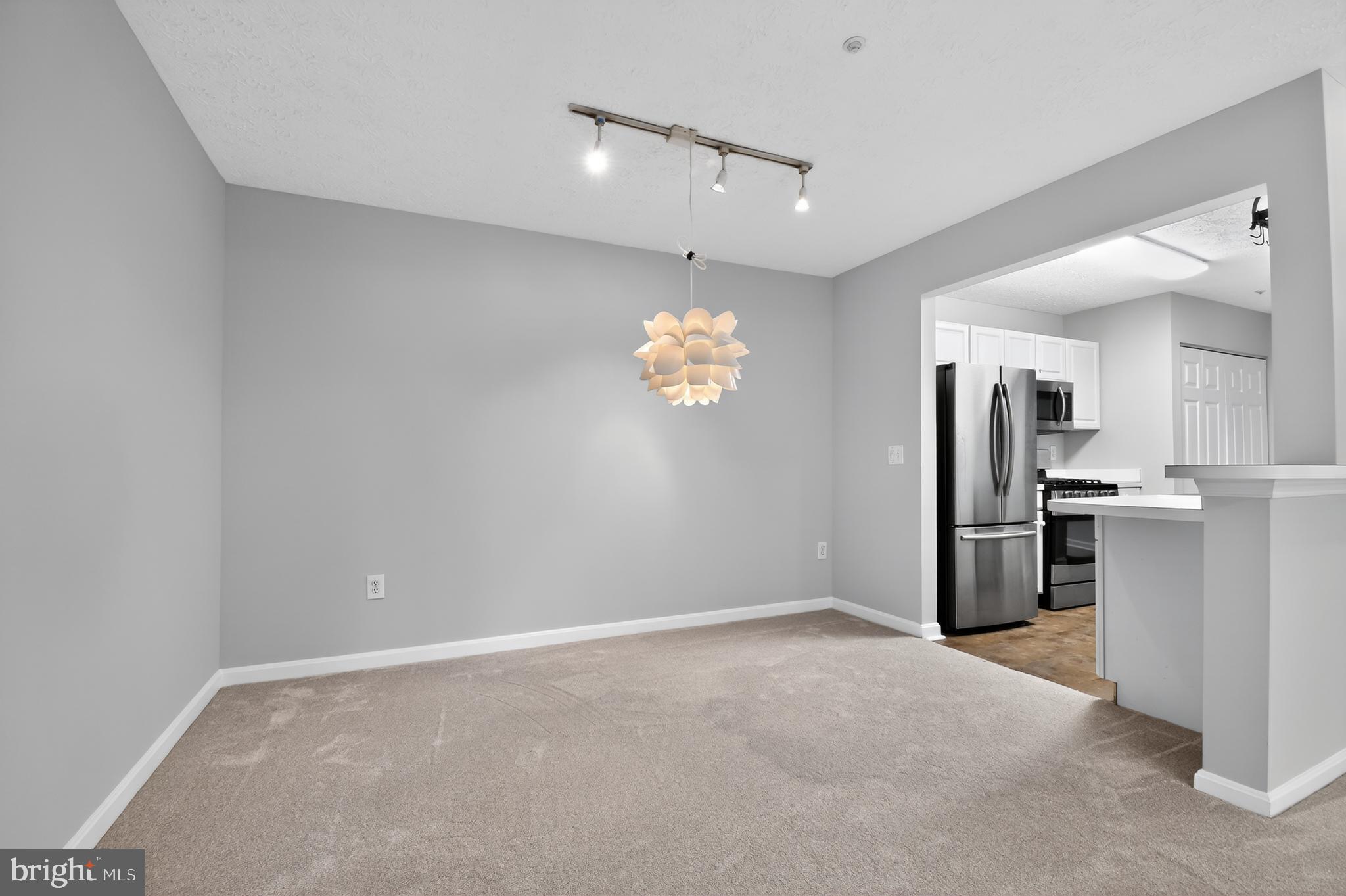 2058 Quaker Way, Unit 12 Annapolis, MD 21401 - Photo 14 of 27 a view of a kitchen with a refrigerator a ceiling fan and a refrigerator
