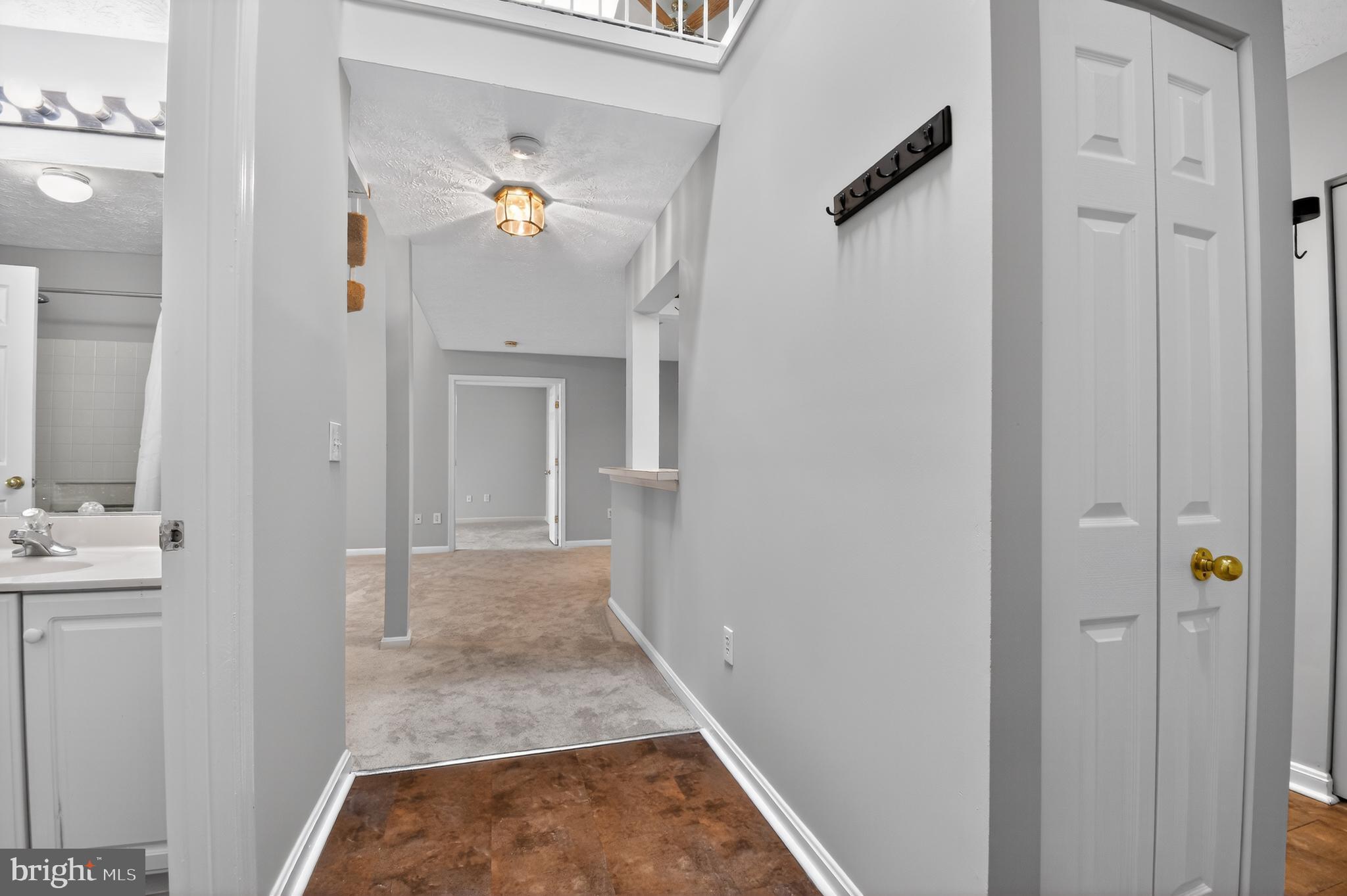 2058 Quaker Way, Unit 12 Annapolis, MD 21401 - Photo 2 of 27 a view of a hallway with wooden floor and cabinet