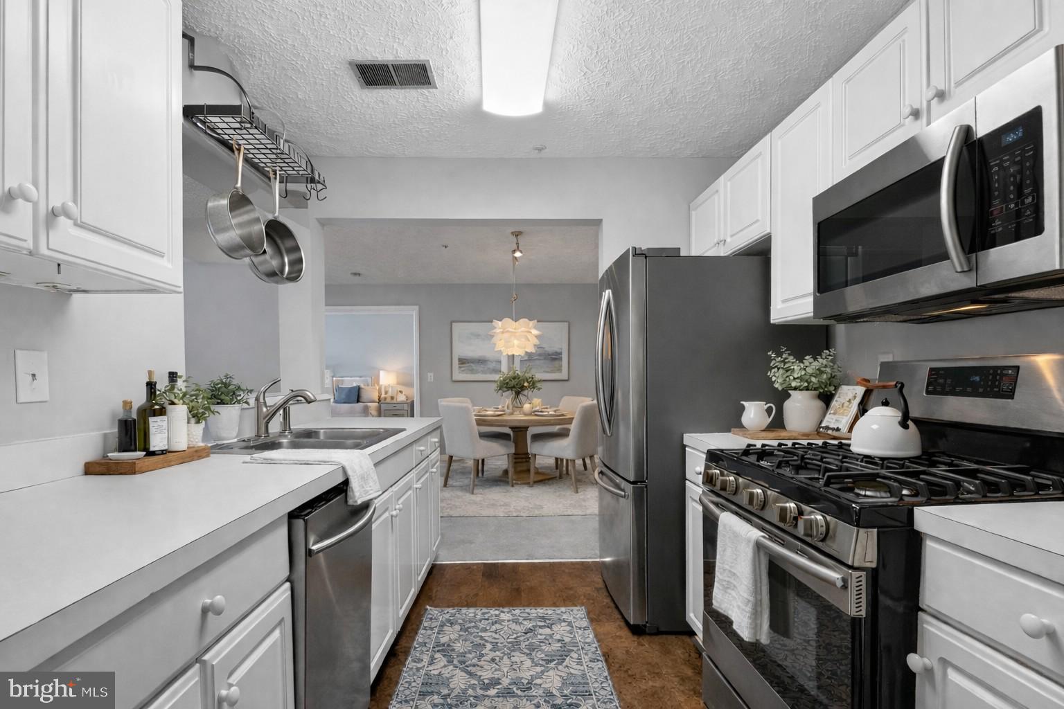 2058 Quaker Way, Unit 12 Annapolis, MD 21401 - Photo 22 of 27 a kitchen with stainless steel appliances a stove a sink dishwasher a refrigerator and a microwave