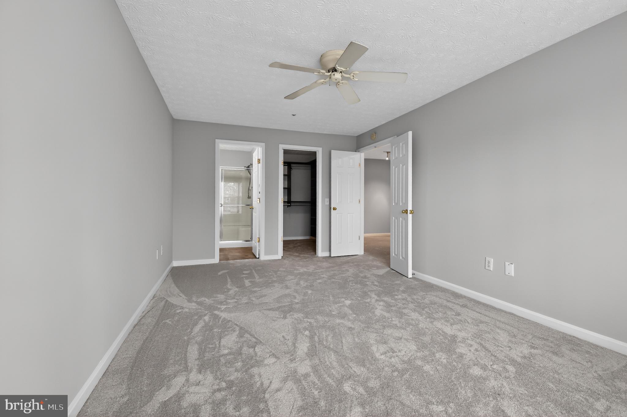 2058 Quaker Way, Unit 12 Annapolis, MD 21401 - Photo 6 of 27 a view of an empty room with a ceiling fan