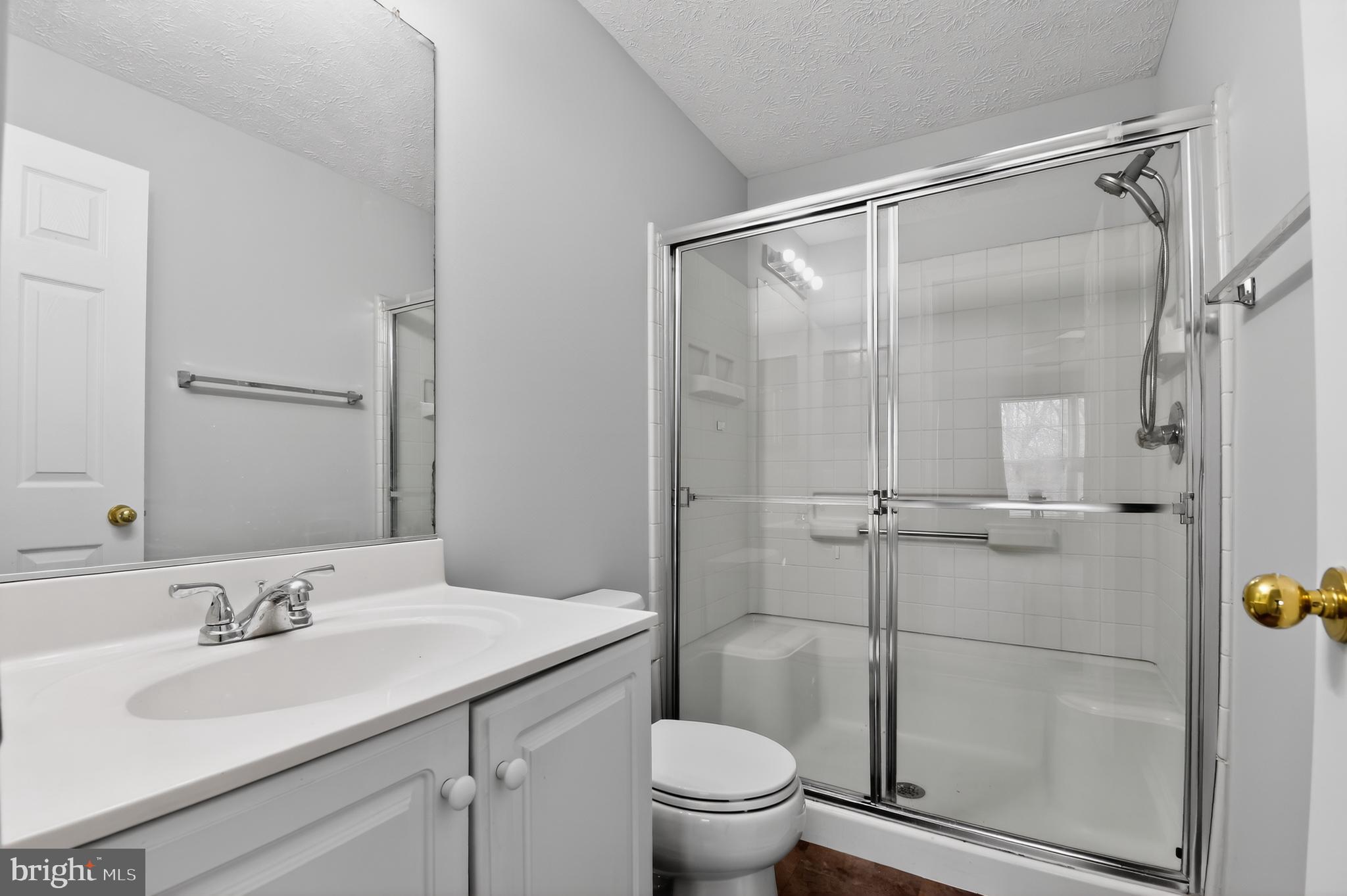 2058 Quaker Way, Unit 12 Annapolis, MD 21401 - Photo 8 of 27 a bathroom with a granite countertop sink toilet and shower
