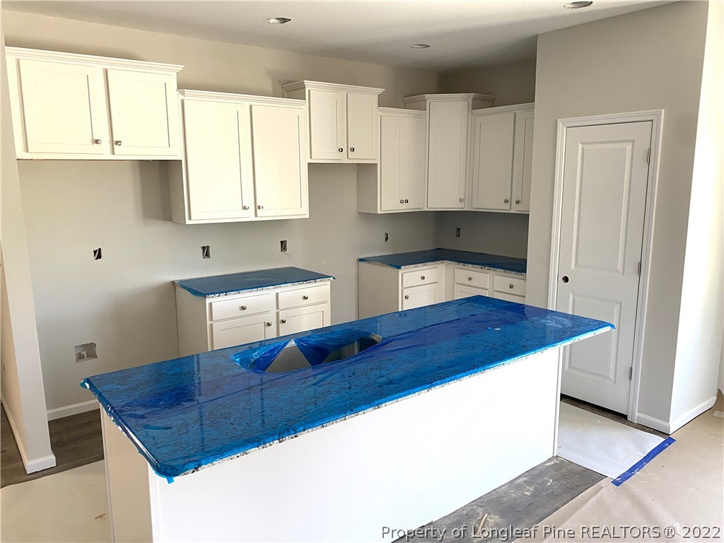 601 Laurel Lake Road Salemburg, NC 28385 - Photo 3 of 17 a kitchen with stainless steel appliances kitchen island sink refrigerator and cabinets
