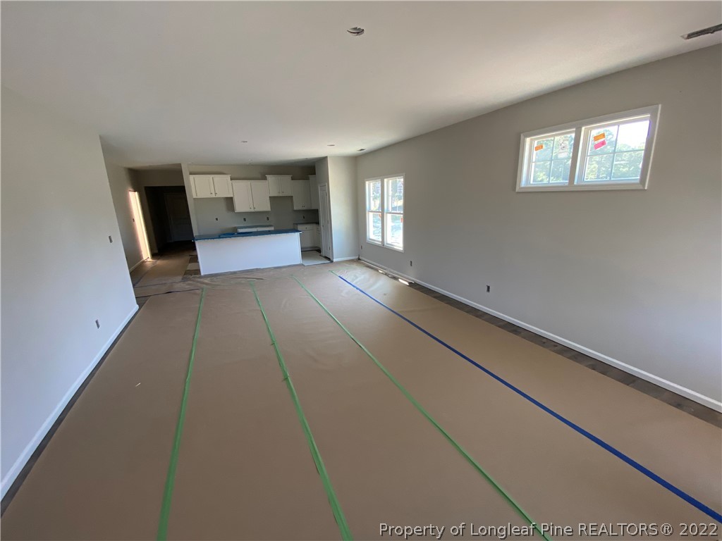 601 Laurel Lake Road Salemburg, NC 28385 - Photo 4 of 17 a view of empty room with a fireplace and window