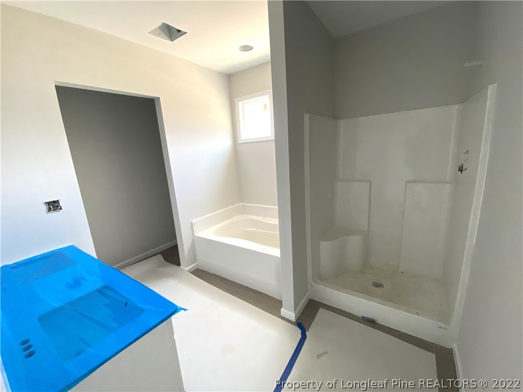 601 Laurel Lake Road Salemburg, NC 28385 - Photo 6 of 17 a bathroom with a tub shower and sink