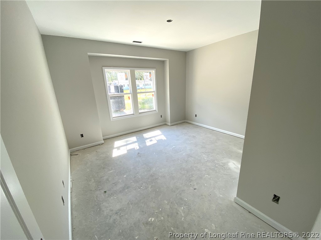 601 Laurel Lake Road Salemburg, NC 28385 - Photo 10 of 17 an empty room with a empty space and windows