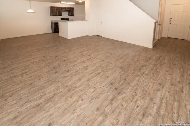 a view of a kitchen with wooden floor
