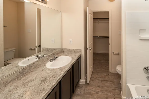 a bathroom with a granite countertop sink and a mirror