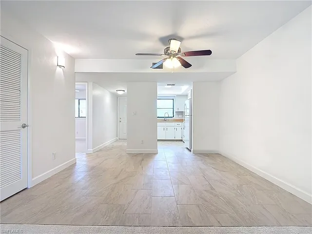 an empty room with fan and a ceiling fan