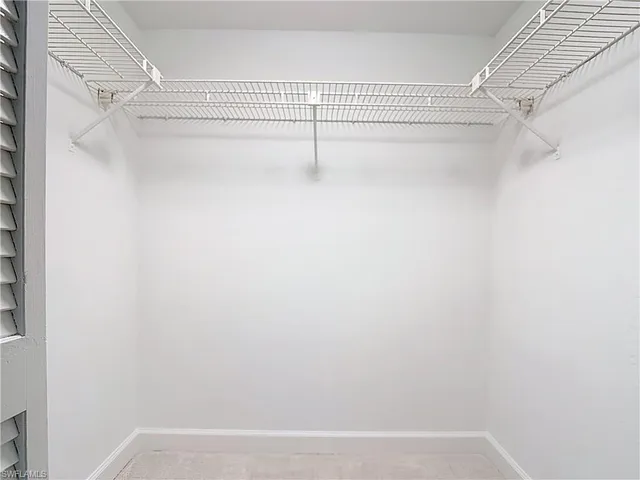 a view of a chandelier fan and closet