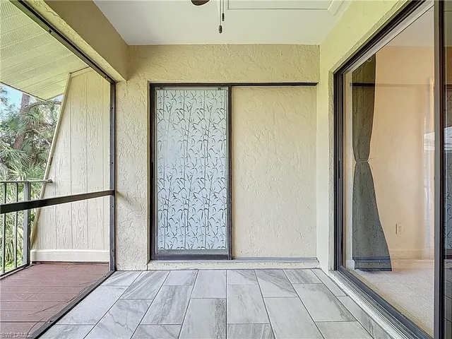 a view of empty room with large windows