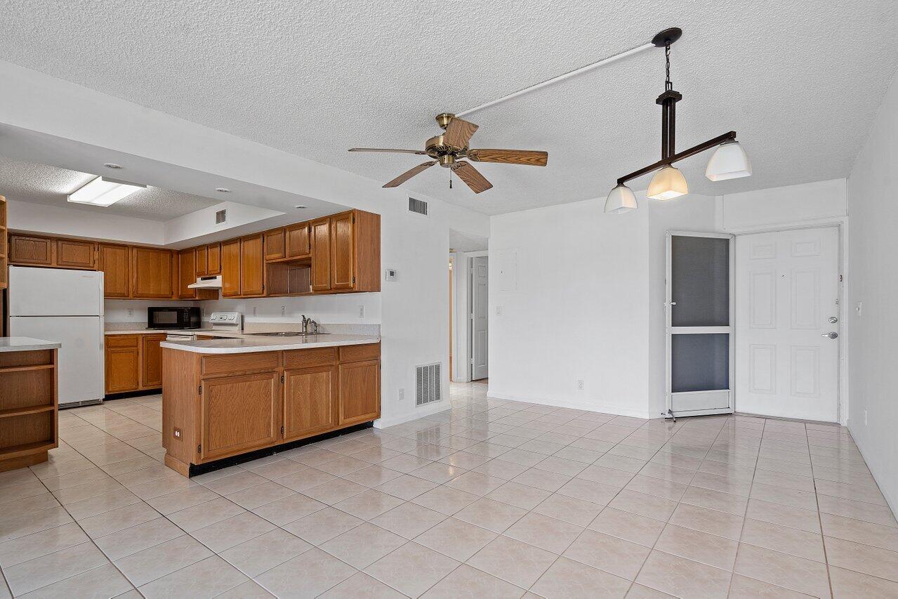 3190 Leewood Terrace, Unit L104 Boca Raton, FL 33431 - Photo 3 of 24 Entry/Kitchen