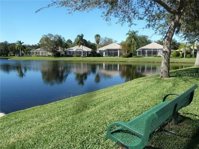 a view of a lake with houses in the back