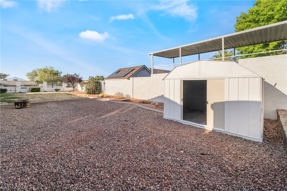 429 Crestway Road Henderson, NV 89015 - Photo 48 of 56 A spacious backyard features a utility shed and low-maintenance gravel landscaping.