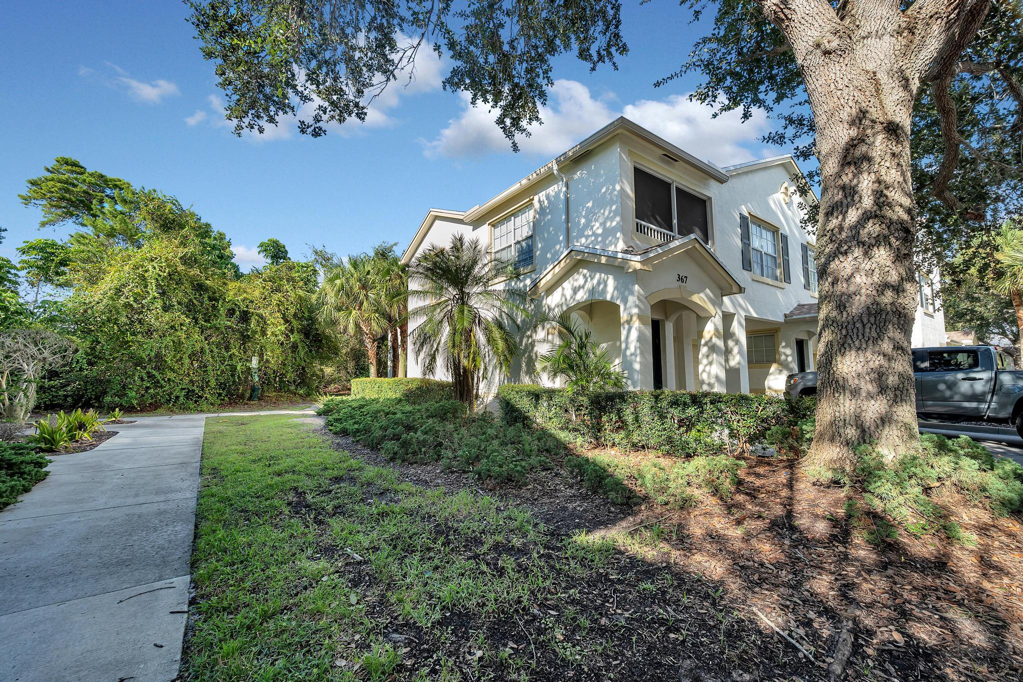 367 Southeast Rogers Court Stuart, FL 34994 - Photo 1 of 35 a front view of a house with a yard