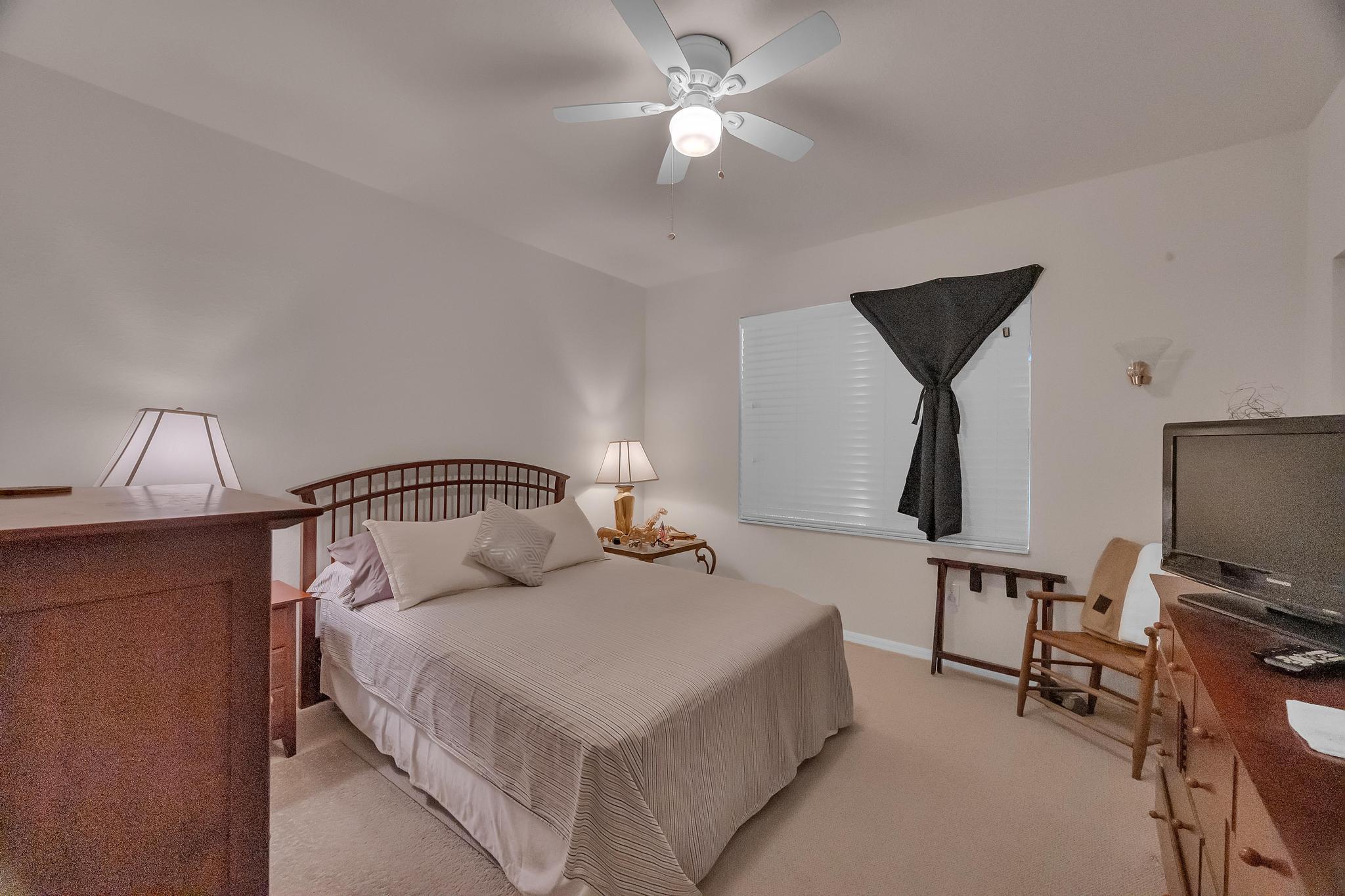 367 Southeast Rogers Court Stuart, FL 34994 - Photo 11 of 35 a bedroom with a bed and a flat screen tv